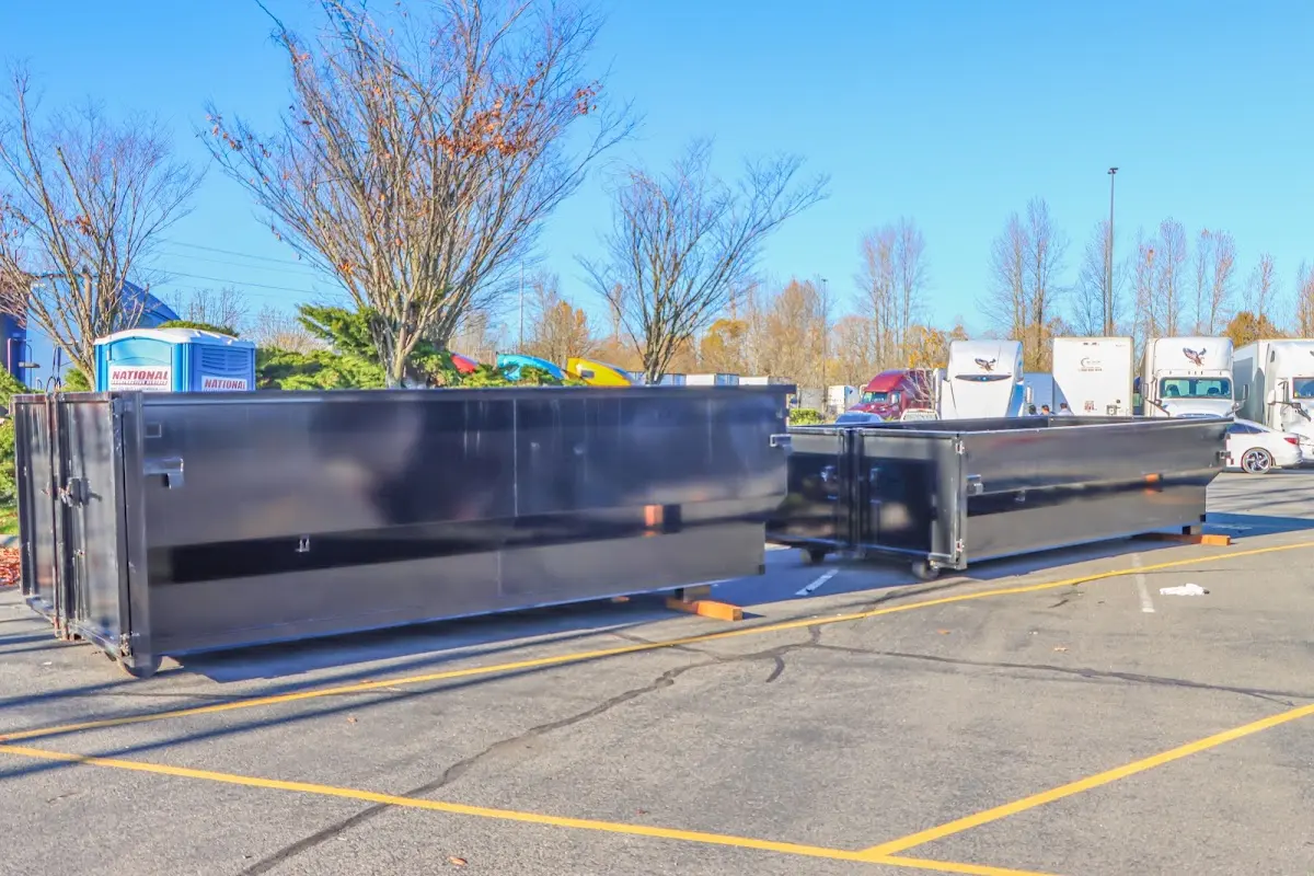 Professional dumpster rental service with roll-off container on residential driveway in Newport News